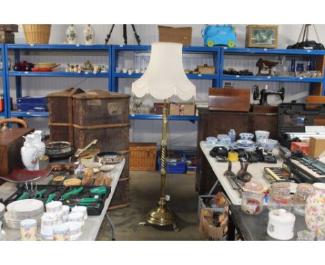 A brass standard lamp and shade