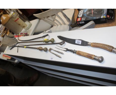A horn handled carving knife and fork; fire irons and a pair of nutcrackers