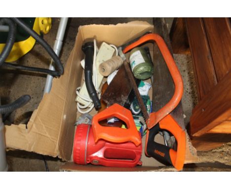 A box of various hand tools including hand saws