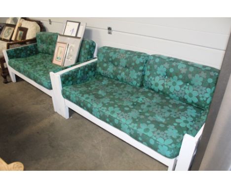 A pair of white framed sofa beds