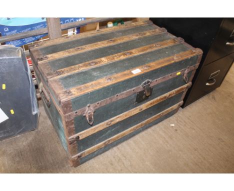 A canvas wood and metal bound travelling trunk with interior tray