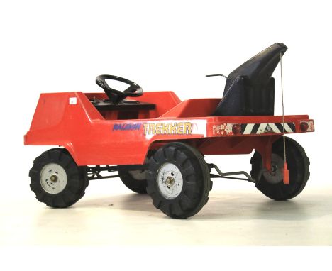A 1970s red Raleigh Trekker child's sit-on pedal tow trunk. Marked 'RAL7M', L94cm