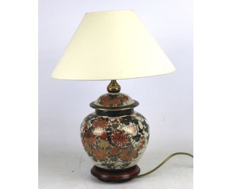 A ceramic Oriental bulbous shaped table lamp with shade H47cm.