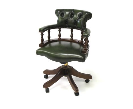 A reproduction Victorian style captains swivel chair. The wooden frame with carved spindles and shaped arm rests, upholstered