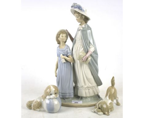 Three Nao ceramic figures. Comprising a large figure featuring two girls, H38cm, and two models of spaniels