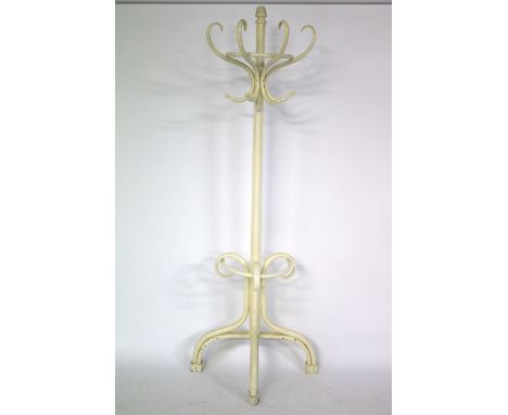 A vintage coat rail. Painted white, with two tiers of hooks to the upper section, an umbrella stand to the lower section, on 