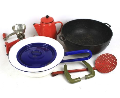 An assortment of kitchenalia. Including enamel pans, a cast iron pan, vintage mincer etc.