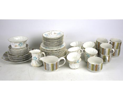 A Staffordshire Midwinter part tea service and another tea service. The other tea service decorated with blue and gilt flower