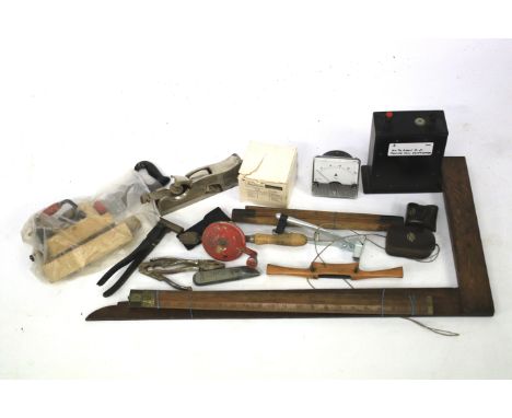 An assortment of tools. Including rulers, knives, pliers, electrical measuring tools etc