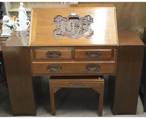 A hardwood bureau. Carved with a Chinese seascape and boats to the lid and handles, the front opening to reveal a fitted inte