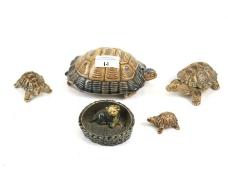 A collection of vintage Wade porcelain ornaments. Including four various sized tortoise figurines and a puppy in a basket. Ma