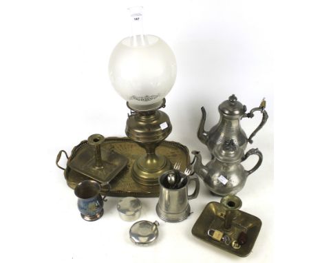 An assortment of metalware. Including pewter tankards, a brass oil lamp with a glass shade decorated with flowers, H53cm, an 