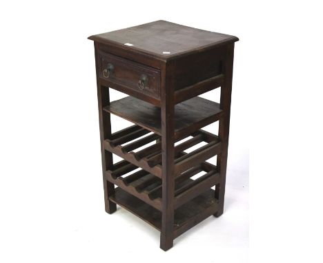 A vintage stained wooden cupboard. The upper section with a single drawer, the lower section with a single shelf and two bott