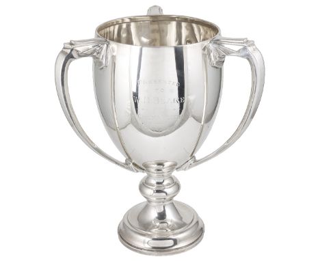 A GEORGE V SILVER THREE-HANDLED TROPHY CUP, ADIE BROTHERS LTD., BIRMINGHAM, 1931knopped circular foot, the otherwise plain ov