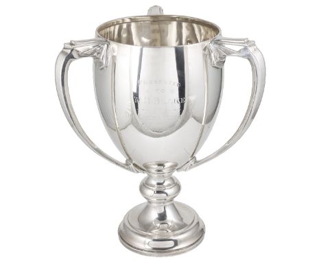 A GEORGE V SILVER THREE-HANDLED TROPHY CUP, ADIE BROTHERS LTD., BIRMINGHAM, 1931knopped circular foot, the otherwise plain ov