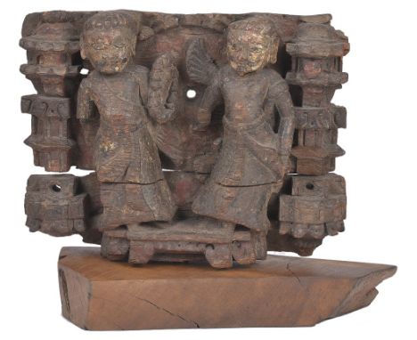 A WOOD ARCHITECTURAL FRAGMENT, GUJARAT, WESTERN INDIA, CIRCA 18TH CENTURYpainted and carved in relief, depicting a pair of fi
