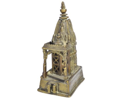 A MINIATURE SAIVITE SHRINE, NORTHERN INDIA, POSSIBLY DATED SAMVAT 1520/1464 ADbrass, on raised plinth, with composite shikara
