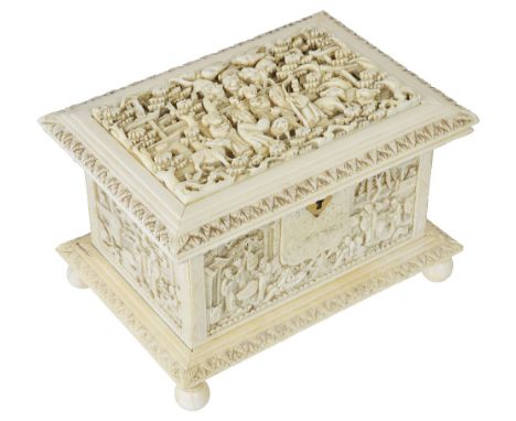 ~A CHINESE IVORY CASKET, PROBABLY CANTON, MID 19TH CENTURYrectangular, with stiff leaf borders, the cover deeply carved with 