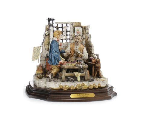 CAPO DI MONTE CERAMIC GROUP'La Bottega Del Calzolaia' (The Shoe Maker Shop), modelled by Walter Scapinello, 20cm high, on woo