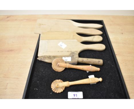 A pair of wooden pastry siggers having fluted wheels L13.5cm, sold together with 4 Scotch hands/butterpats and a wooden lemon