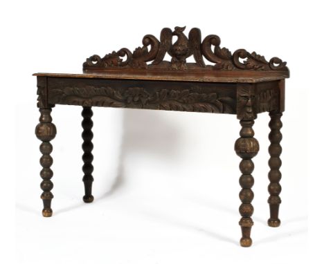 A Victorian carved oak hall table, the pierced carved gallery with a bird flanked by scrolling acanthus, the gallery with a G