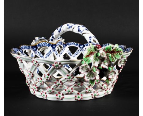 A Worcester style porcelain basket, in the 1770s style but 20th century, blue M mark, decorated with exotic birds in landscap