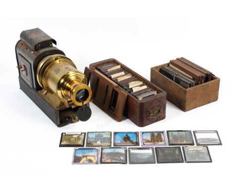 A tin and brass Magic Lantern and a collection of glass and moving hand painted slides
