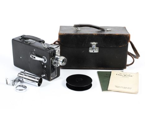 A cased early 20th century Kodak Cine camera model K, bearing US patent numbers, fitted with F-1.9 25 mm lens and with additi