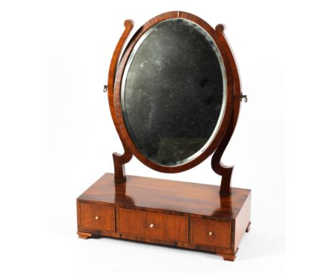 A Victorian rosewood dressing table mirror, the oval swing mirror above a rectangular base with three drawers, on bracket fee
