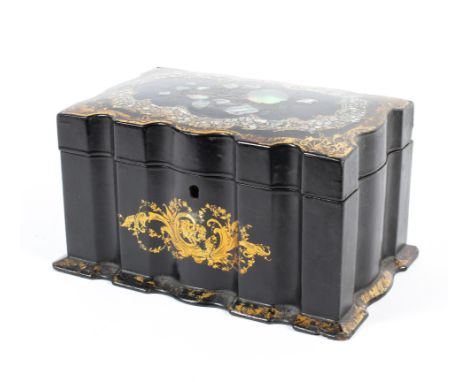 A Victorian papier mache tea caddy, of serpentine form, inlaid with mother of pearl flowers to the top within gilt scroll car