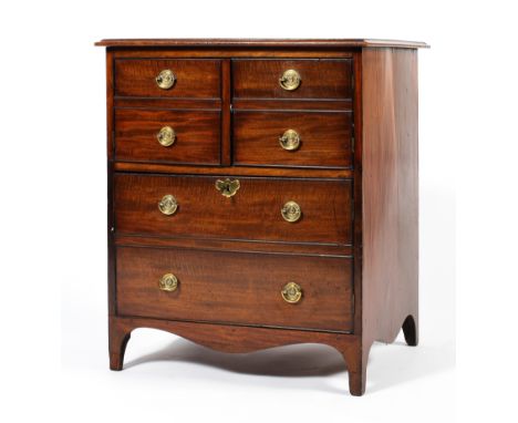 A Georgian mahogany pot cupboard, the moulded top above two panelled doors above a cupboard, with key and brass fittings, on 