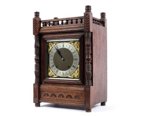 A Continental oak cased bracket clock, early 20th century, the silvered chapter ring with Roman numerals, with gilt metal ang