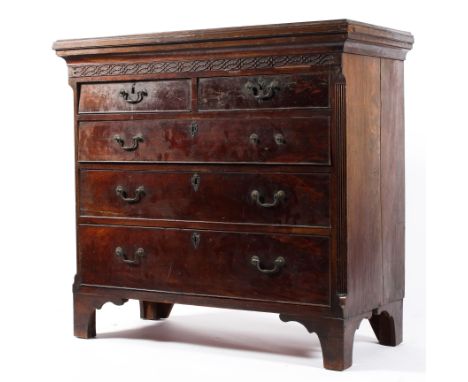 A Georgian mahogany chest of drawers, the moulded later top above a flowerhead and ovolo carved frieze, with two short drawer