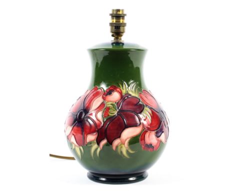 A Moorcroft Clematis pattern table lamp, 20th century, impressed marks, of baluster form, on a green ground, fitted for elect