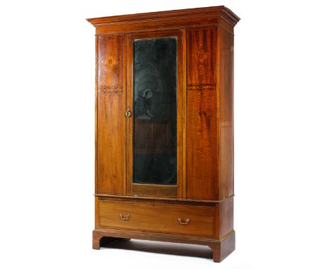 A late Victorian mahogany marquetry wardrobe, with moulded cornice above a central door mounted with a bevelled mirror, enclo