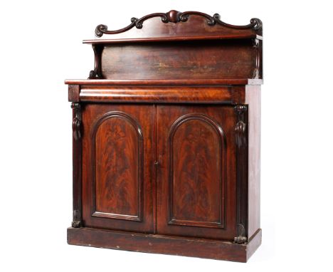 A Victorian mahogany chiffonier, mid-19th century, with foliate scroll carved back and shelf, with moulded frieze drawer abov