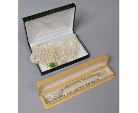 A Freshwater Pearl Six String Necklace Together with a White Stone Necklace 