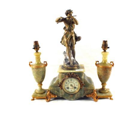 A French Onyx and gilt metal mantel clock with spelter flute player mount