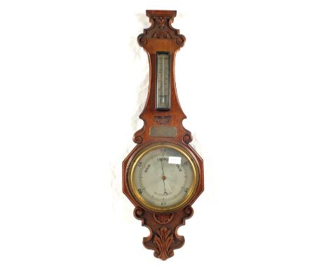 A carved Oak aneroid barometer plus one other (broken glass)