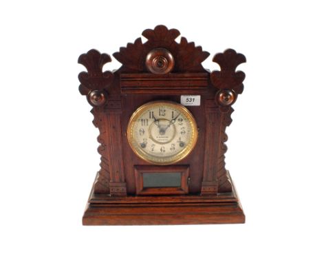 An American Oak Welch's mantel clock retailed by R.Greene, Norwich