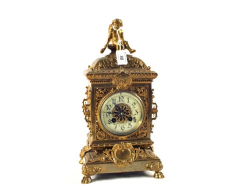 A French gilt Brass mantel clock with part blue enamel dial and pierced case with cherub mount on claw feet