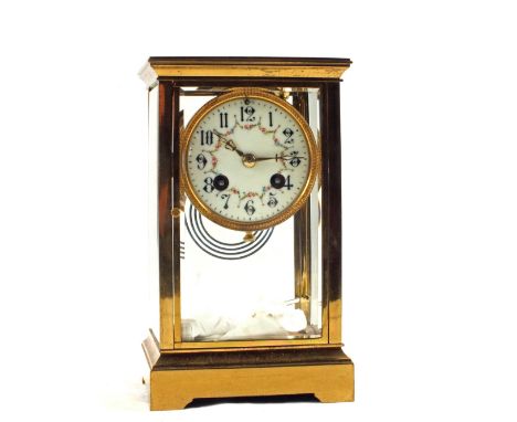 A Brass cased four glass striking mantel clock with painted enamel dial