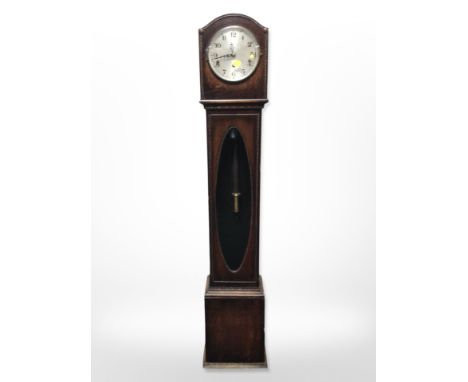 An early-20th century oak grandmother clock with silvered dial, height 142cm.