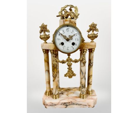 A 19th century French peach marble and gilt metal portico mantel clock, striking on a bell, with pendulum and key, height 41c