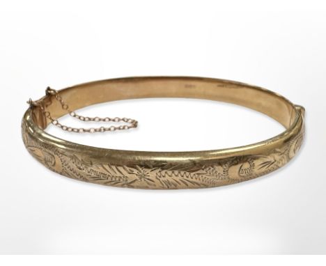 A 9ct yellow gold bangle, diameter 7 cm x 6 cm CONDITION REPORT: 10.1g.