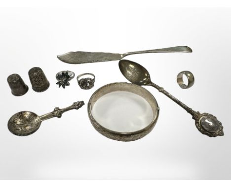 A group of silver items to include bangle, two thimbles, three rings, fish knife, two spoons. CONDITION REPORT: 114g.