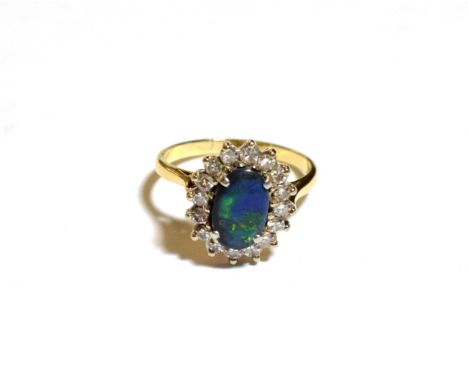 A black opal and diamond cluster ring, stamped '18CT', finger size Q.  Gross weight 4.4 grams. 