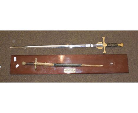 An Elizabeth II presentation sword by Wilkinson Swords, the double edge steel blade etched with presentation inscription BRYA