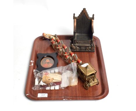 A lock of hair, circa 1825, reputedly belonging to George III, bearing wax seal; a cast iron throne form money bank; a Corona