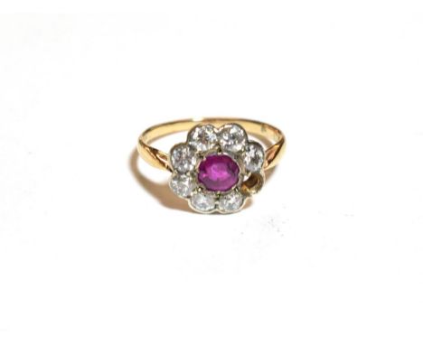 A ruby and diamond cluster ring, finger size M1/2  One stone loose but present  .  Unmarked. Gross weight 2.57 grams. 